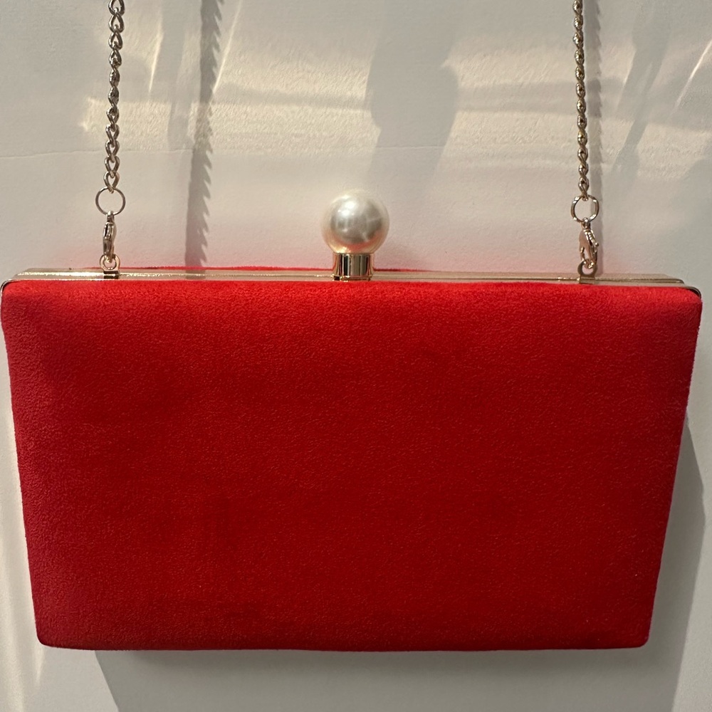 Elegant Red Clutch Bag with removable chain strap . New condition.